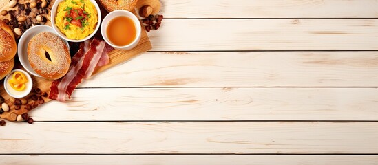 Wall Mural - Hearty breakfast with bacon bagels and scrambled eggs on the table