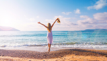 Wall Mural - Woman in white dress relaxing and enjoying beautiful tranquil beach- Travel, summer vacation concept