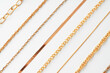 Jewelry set of golden chains on the white background