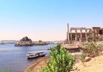 Wall Mural - Temple of Isis on Agilkia Island (Philae) and boats on the Nile river, reservoir of Aswan Low Dam, Egypt. Summer vacation, relaxing on cruise ships