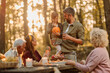 © bernardbodo - Happy family having a picnic in the woods
