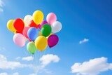 Fototapeta Nowy Jork - rainbow-colored balloons floating in the sky