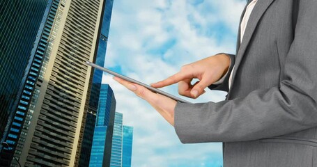 Poster - Composite view of mid section of businesswoman using digital tablet against tall buildings