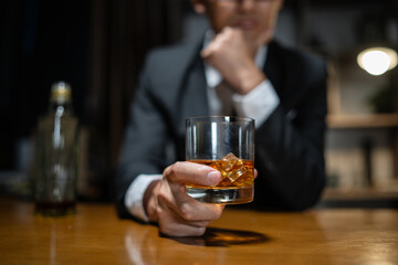 Businessman wearing a suit whiskey glass of liquor.