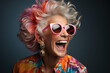 © syhin_stas - Portrait of happy glamorous senior woman in glasses on a black background.Energetic Grandma with hairstyle in stylish outfit.