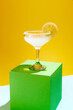 Sweet and sour, popular margarita cocktail with lemon slice decoration isolated over yellow background. Concept of alcohol drinks, party, holidays, bar, mix. Poster. Copy space for ad