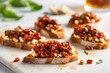 bruschetta with sundried tomatoes and goat cheese on a marble tray