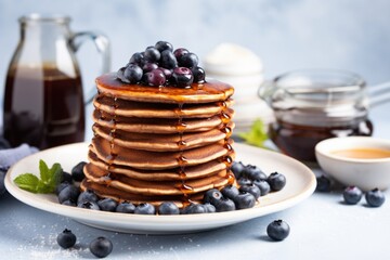 Wall Mural - stack of vegan pancakes with maple syrup and blueberries