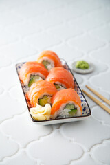 Wall Mural - Salmon sushi rolls with cucumber and avocado