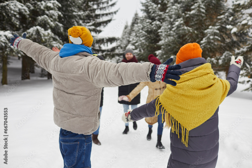 Group of excited young friends having fun outdoors in winter with their ...
