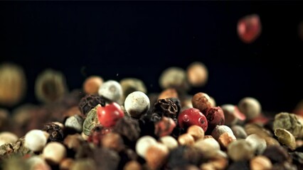 Sticker - Peppercorn falling on a black background. Filmed on a high-speed camera at 1000 fps. High quality FullHD footage