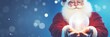 Happy Santa Claus holding glowing christmas ball over defocused blue background with copy space. Panoramic