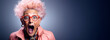 surprised old elderly fashionable woman with glasses on a blue background