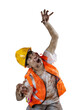 A scary construction worker zombie with blood and wounds on his body walking
