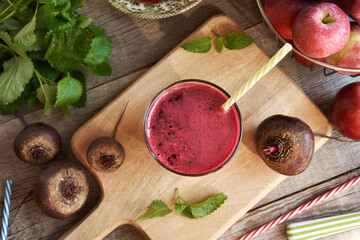 Wall Mural - Fresh beetroot juice with apples on a table, top view