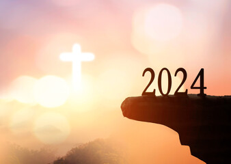Wall Mural - New hope concept: 2023 on sunset sky background with white cross