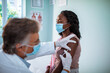 © Marko Geber - Young woman getting a flu shot at the hospital