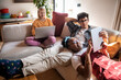 © Marko Geber - Diverse young roommates relaxing on the couch