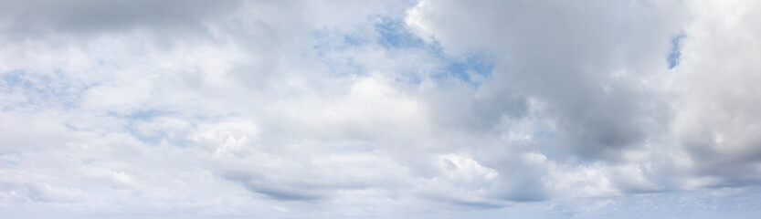 panoramic grey sky with small blue sky patches