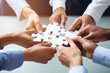 © Jasmina - Business hands, puzzle and group of people for solution, teamwork and goals, integration and success. Team building, synergy and collaboration