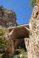 Concrete highway bridge crossing between two mountains.