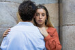 © Raquel - Couple hugging each other looking at the camera