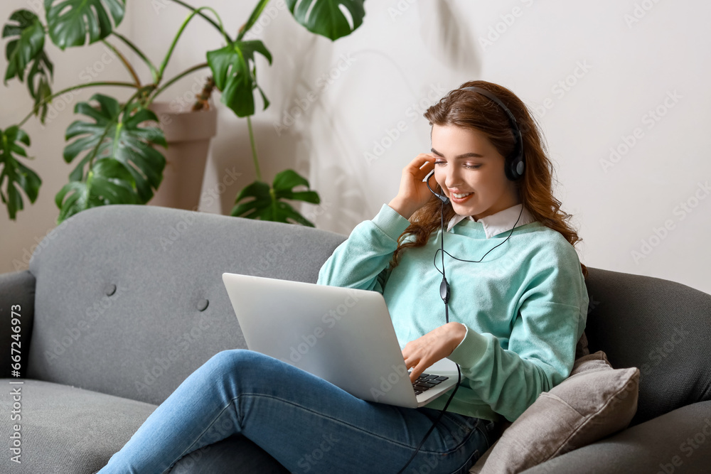 Female technical support agent with laptop working at home