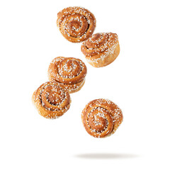 Wall Mural - Fresh baked cinnamon buns flying falling isolated on white background. Traditional swedish sweet pastry kanelbulle.