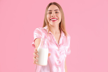 Poster - Young woman with milk on pink background