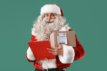 Wall Mural - Santa Claus with clipboard and parcel on green background