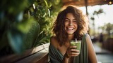 Fototapeta  - Portrait of a woman with a healthy drink, a happy woman with a green detox drink