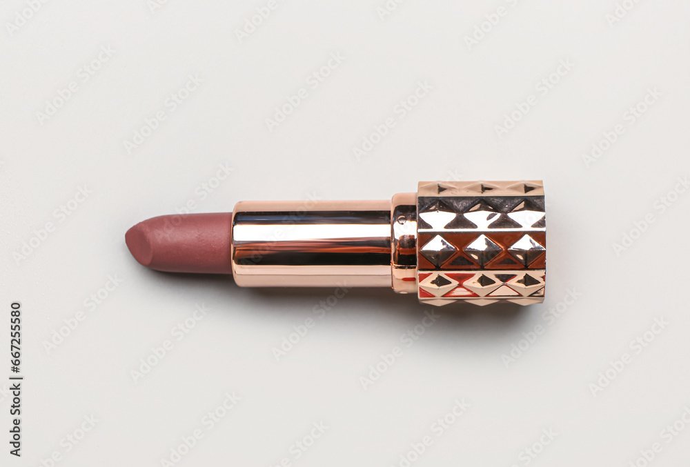 Stylish lipstick on light background