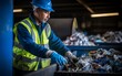 A Recycle worker sorting trash from a conveyor belt at a recycling center. for the environment.