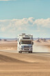 RV that drives at high speed through the desert on a sunny day