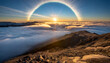sunrise above the clouds from a mountain peak sun creating a halo effect