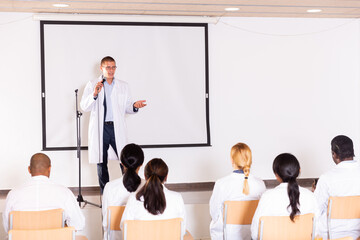 Sticker - Portrait of confident male medical coach giving speech at conference for health workers