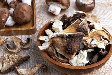 slices of different dried mushrooms in a wooden bowl as gourmet food ingredients, Vegetable organic protein trend food.