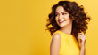 portrait of a happy young woman on a yellow background	