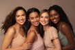© Oulaphone - Portrait of happy diverse multi ethnic young women on beige background.
