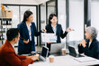 © Nuttapong punna - Business team discuss at meeting room. working together with laptop ,tablet and smart phone on desk Financial accountant , planner , meeting , introduction concept.