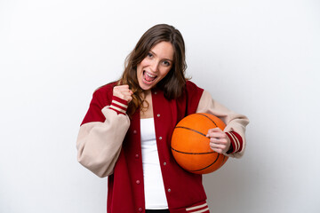 Wall Mural - Young caucasian woman playing basketball isolated on white background celebrating a victory in winner position