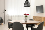 Fototapeta Boho - Stylish dining room interior with comfortable furniture