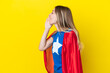 © luismolinero - Super Hero Romanian woman isolated on yellow background shouting with mouth wide open to the lateral