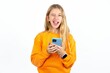 © Roquillo - Excited Beautiful teen blonde girl   winking and eye hold smart phone use read social network news