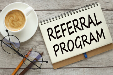 Referral program cup of coffee with notepad with text Tax Planning