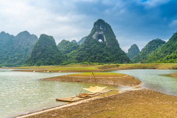 Wall Mural - Aerial view of Thung mountain in Tra Linh, Cao Bang province, Vietnam with lake, cloudy, nature.