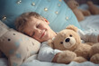 Little son with outstretched hands lying in bed with fluffy stuffed toys animal friends cat and teddy bear sleeping in cozy room. Kid girl covered with blanket enjoy healthy night sleep top view