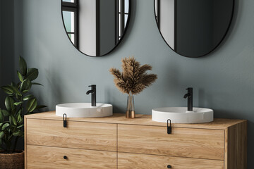 Close up of comfortable double sink with two round mirrors standing on wooden countertop in modern bathroom with blue walls