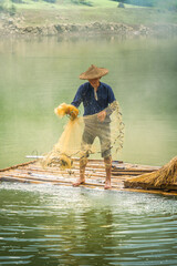 Wall Mural - view of fishermen fishing on river in Thung mountain in Tra Linh, Cao Bang province, Vietnam with lake, cloudy, nature