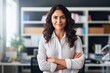 © Viewvie - Happy casual businesswoman looking at camera with crossed arms in office, New generation of energetic entrepreneurs concept.